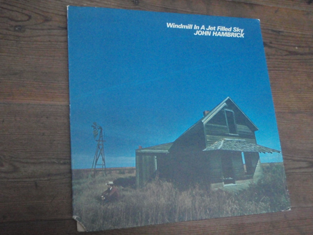 HAMBRICK JOHN.windmill in a jet filled sky.